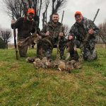 Hunters posing with pheasants